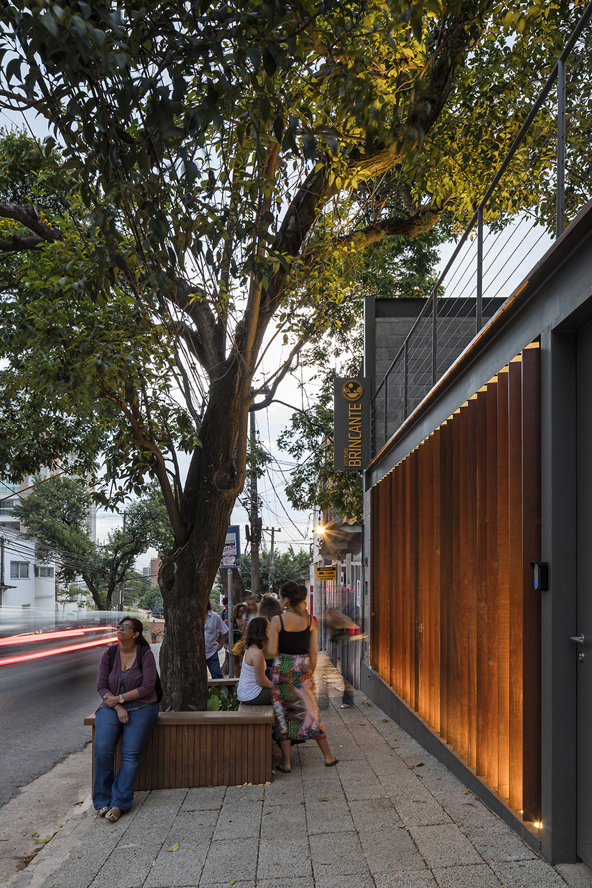 wooden cladding wraps the façade of brincante institute by bernardes arquitetura