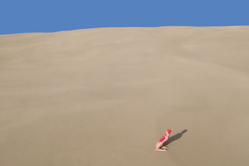 brad walls captures women on sand dunes in his new conceptual aerial photo series
