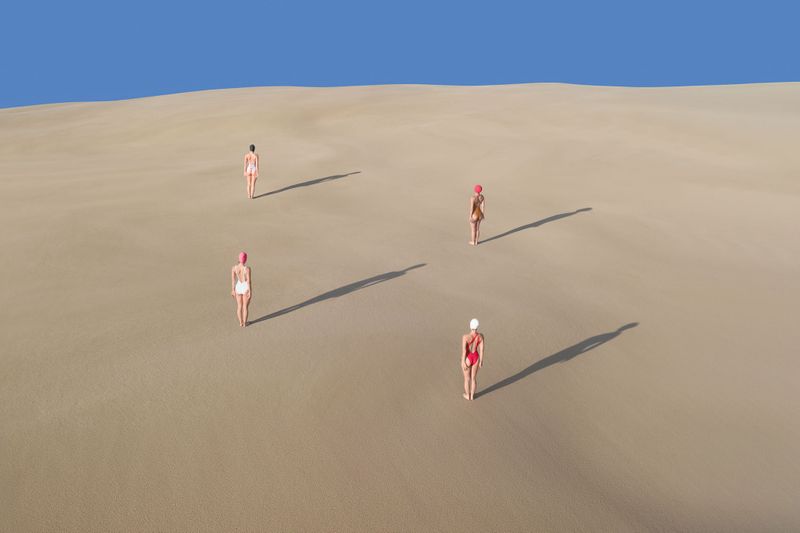 brad walls captures women on sand dunes in his new conceptual aerial photo series