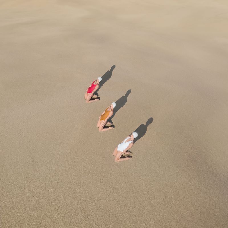 brad walls captures women on sand dunes in his new conceptual aerial photo series