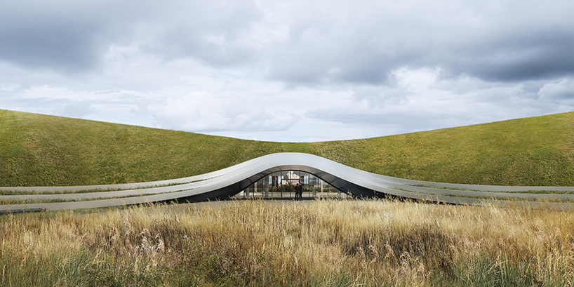 unism studio blends subterranean factory's green roof into poland's rural landscape