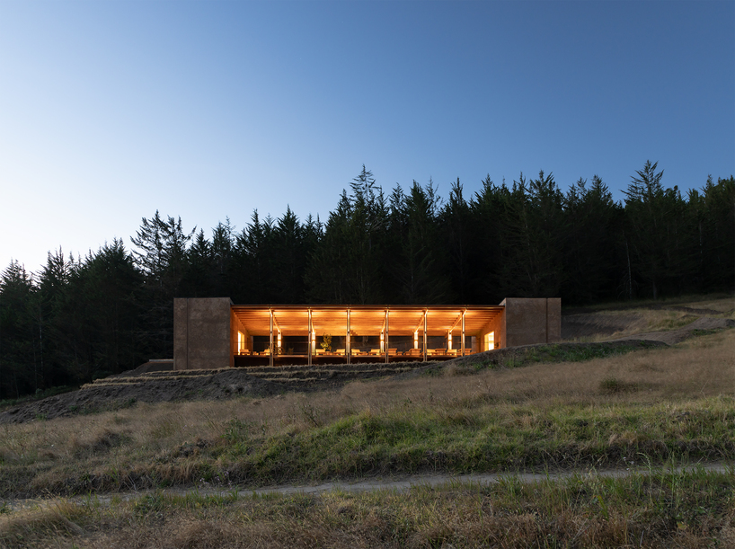 earth-toned concrete bike refuge emerges from ecuador’s reforested landscape - 11