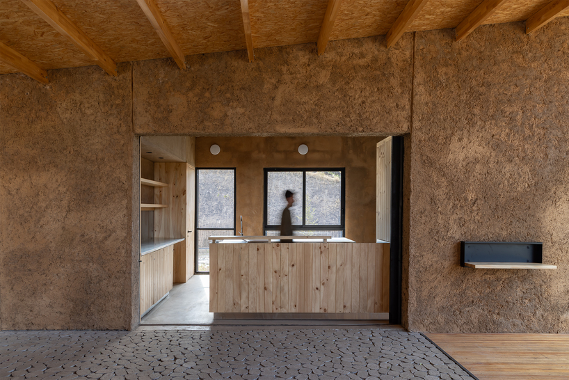 earth-toned concrete bike refuge emerges from ecuador’s reforested landscape - 7