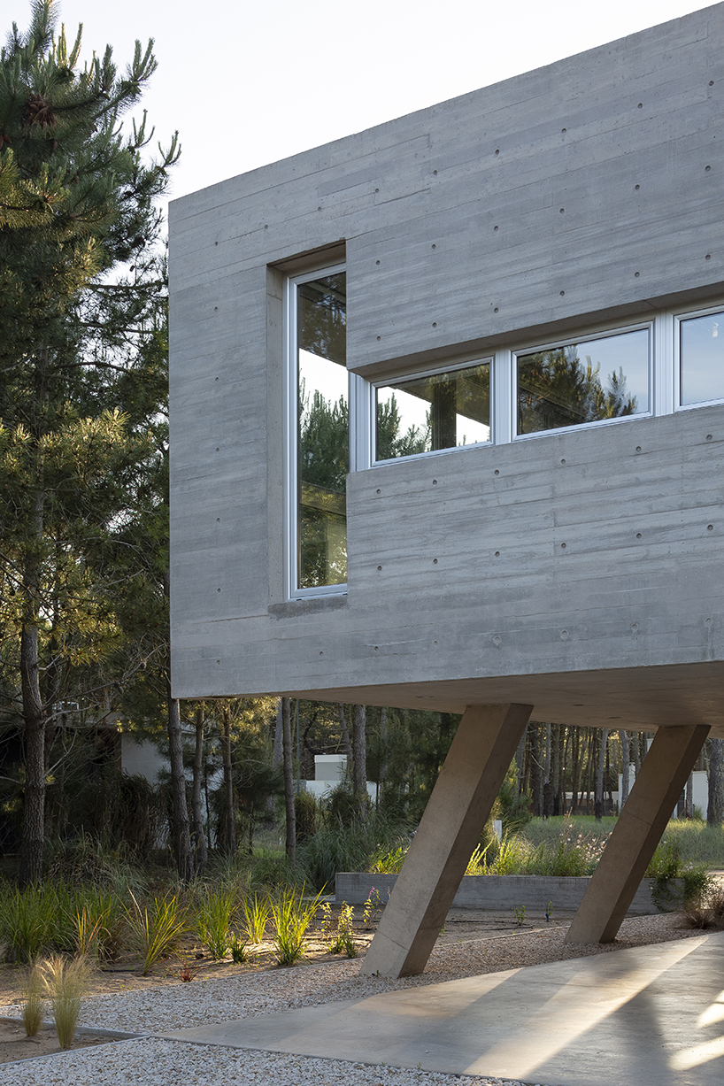 estudio galera rests monolithic home on concrete stilts to maximize space in argentina