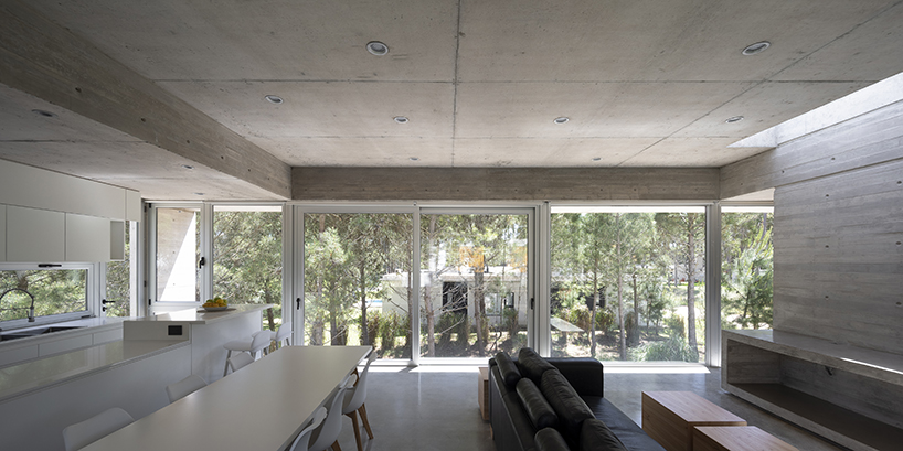 estudio galera rests monolithic home on concrete stilts to maximize space in argentina