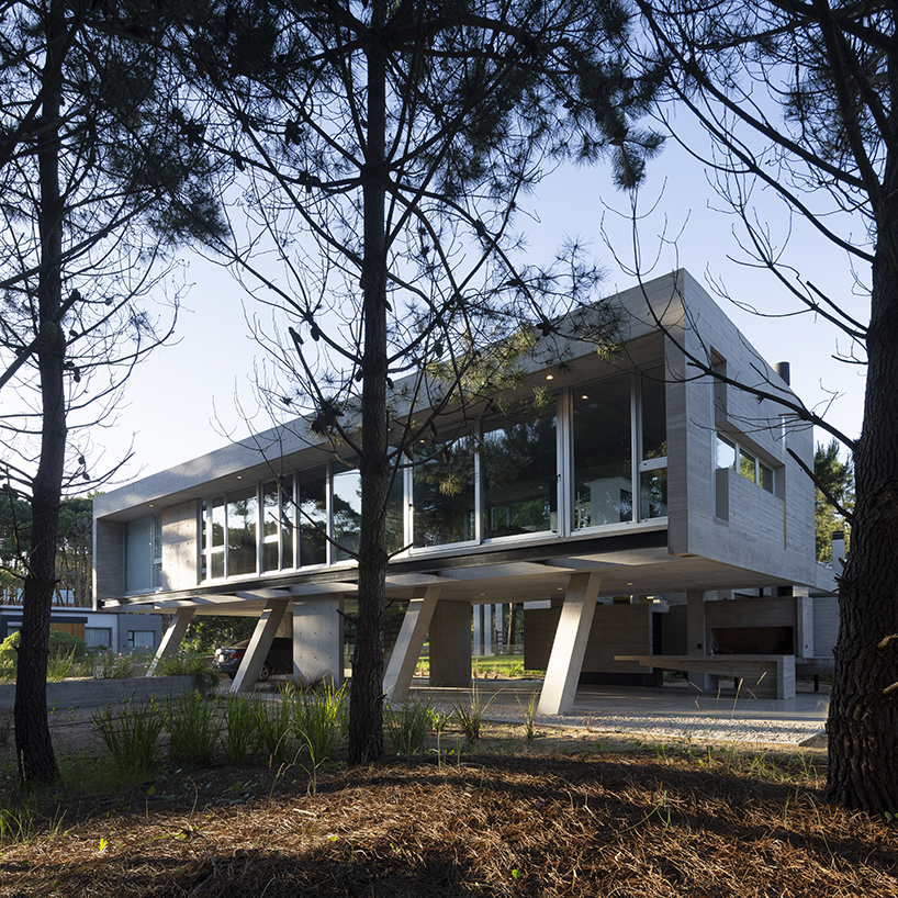 estudio galera rests monolithic home on concrete stilts to maximize space in argentina
