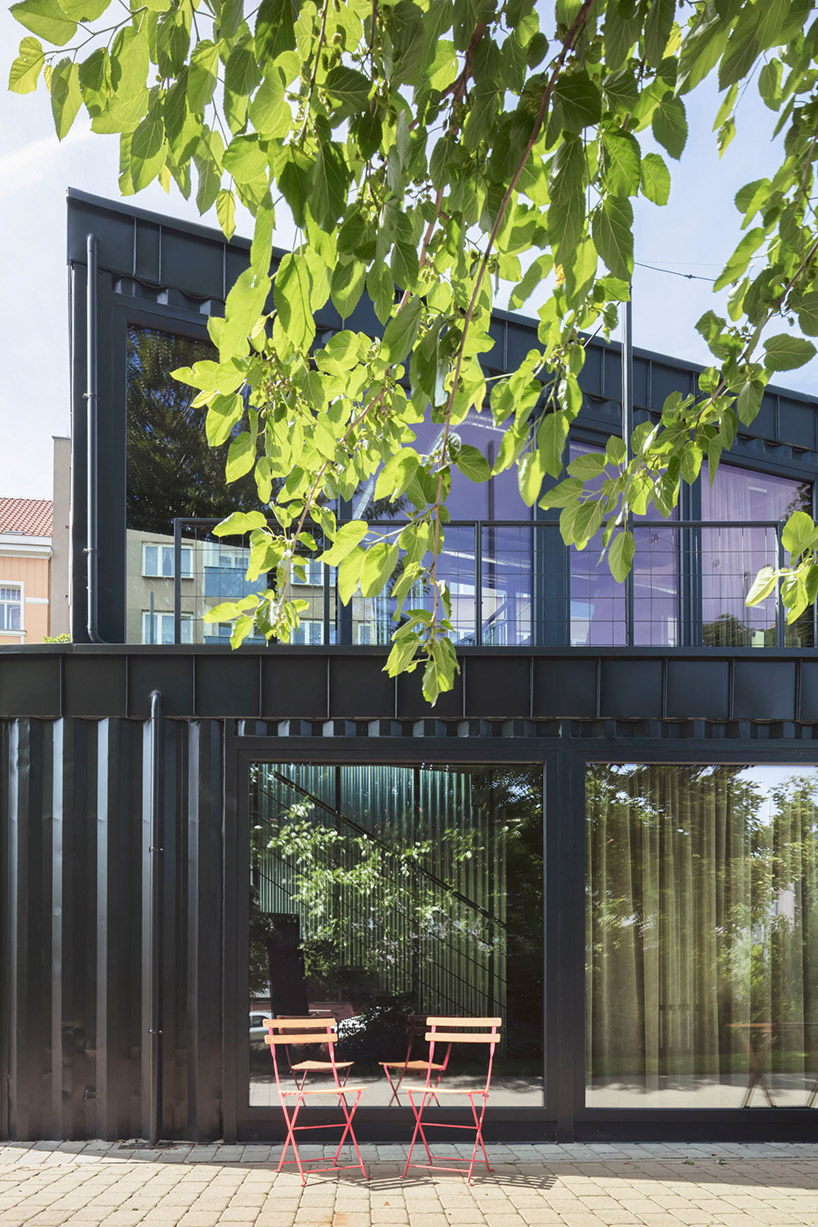 this industrial cafe in prague is made of gray recycled shipping containers