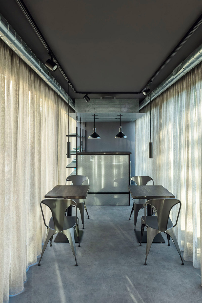 this industrial cafe in prague is made of gray recycled shipping containers