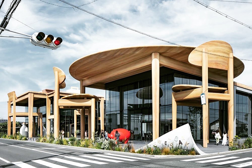 giant set of chairs and table shelters nikken sekkei's mixed-use 'sweets bank' in japan