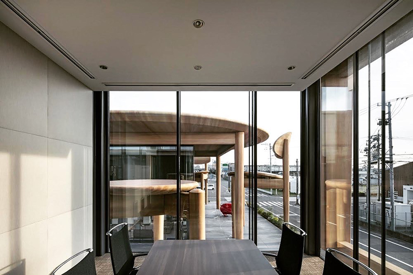 giant set of chairs and table shelters nikken sekkei's mixed-use 'sweets bank' in japan