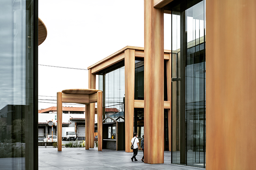 giant set of chairs and table shelters nikken sekkei's mixed-use 'sweets bank' in japan