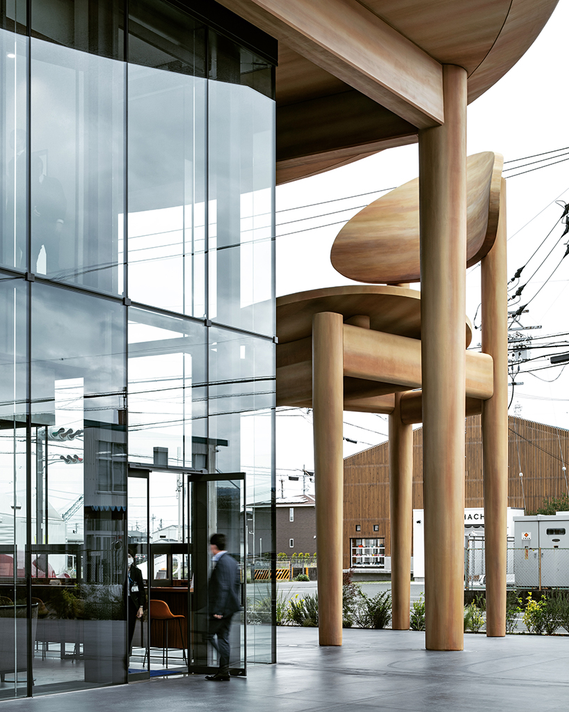 giant set of chairs and table shelters nikken sekkei's mixed-use 'sweets bank' in japan