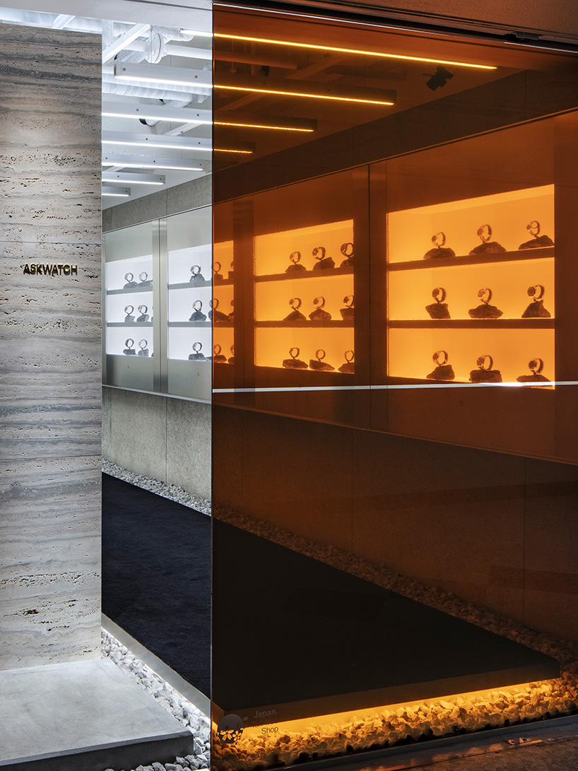 watch store in tokyo peeks through orange stained glass facade