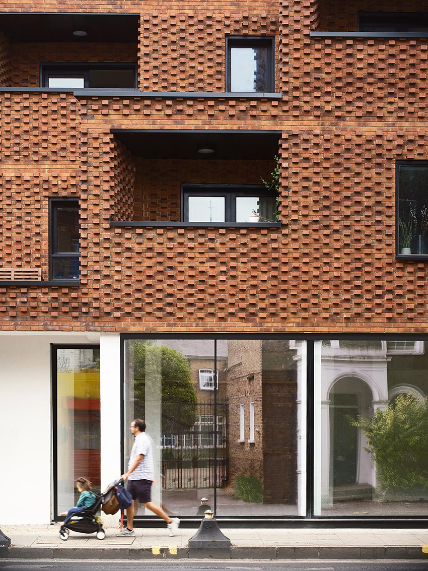 DROO covers residential unit's protruding volumes in textured brickwork in london