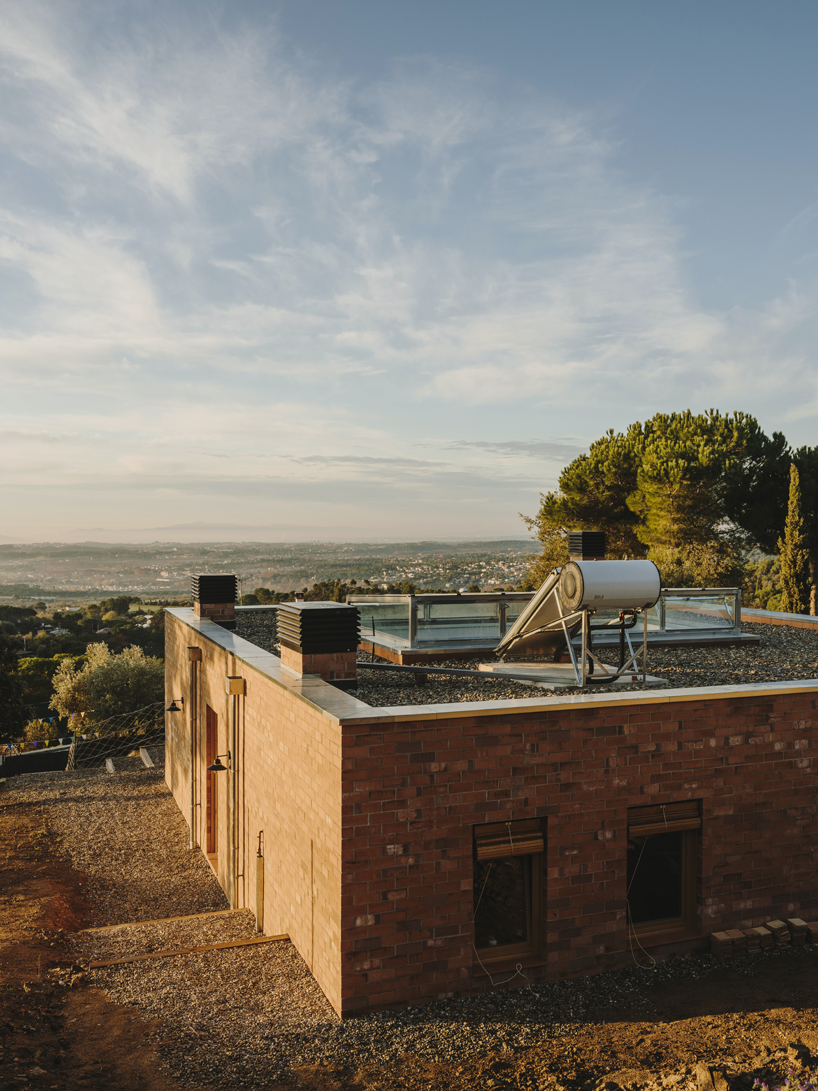 greenhouse-like patio punctures slow studio's passive house in ametlla