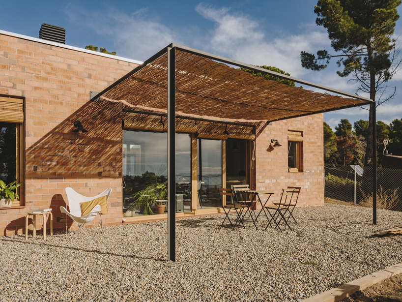 greenhouse-like patio punctures slow studio's passive house in ametlla