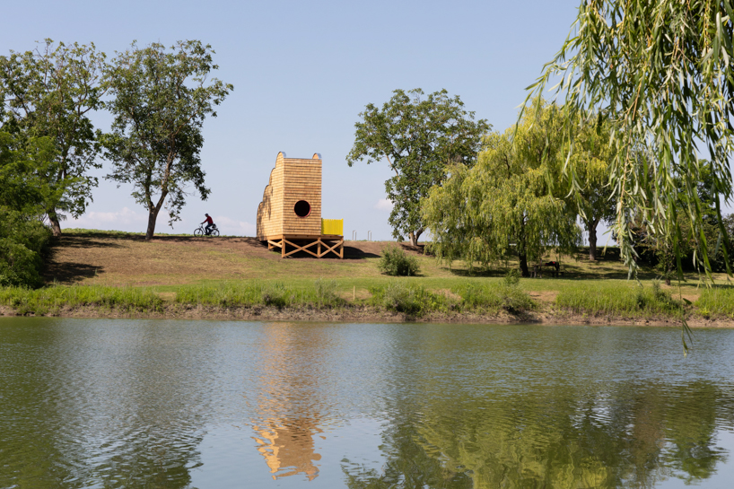 wrapped in wooden shingles, kollektiv plus x's cloud-shaped cyclist shelter ascends to views over iron curtain