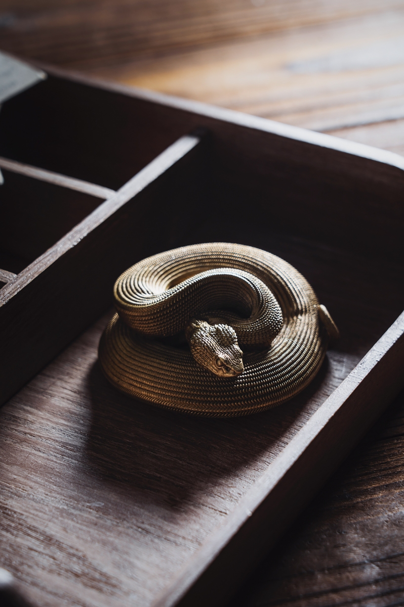 coppertist.wu hand engraves over 14,000 scales on this elegant viper bottle opener