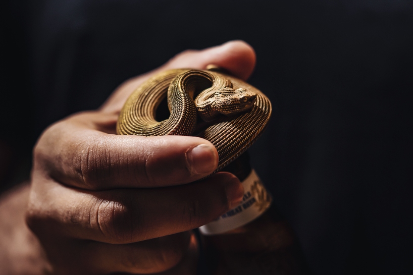 coppertist.wu hand engraves over 14,000 scales on this elegant viper bottle opener