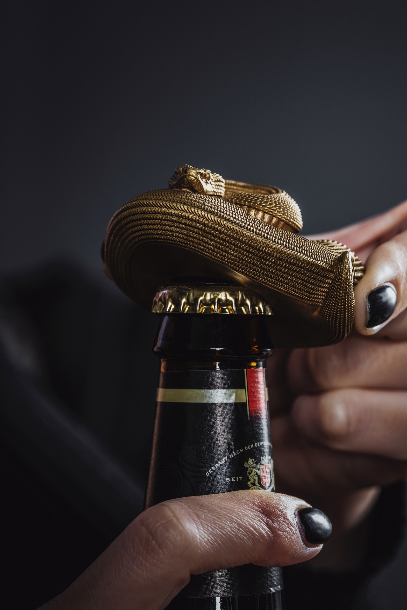 coppertist.wu hand engraves over 14,000 scales on this elegant viper bottle opener