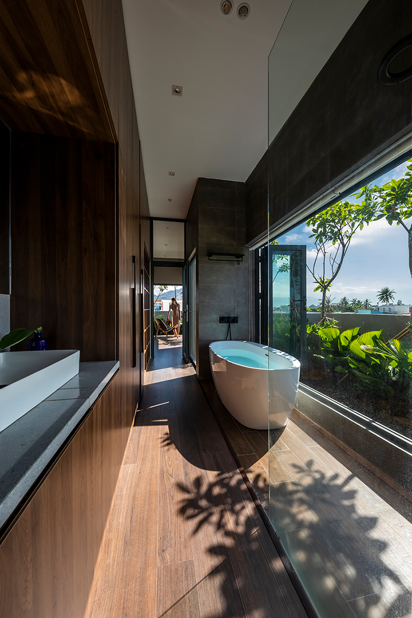 pham huu son weaves small green gardens throughout this sustainable home in vietnam