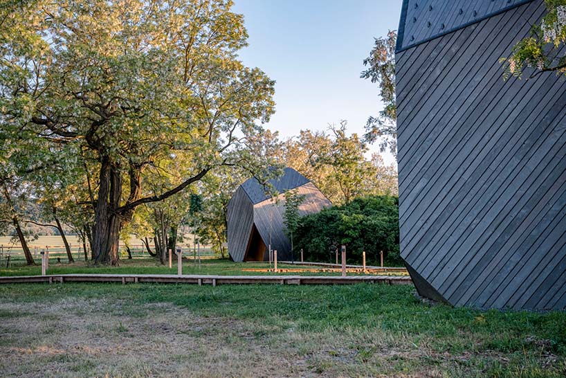 hello wood's resort weaves six boulder-like cabins into rural hungary
