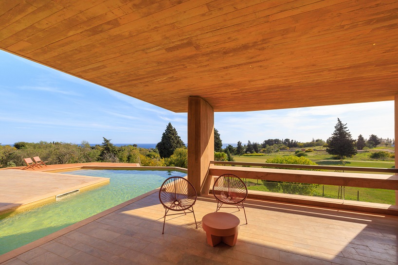 RCR arquitectes’ red concrete resort villa echoes the sandy hues and textures of the algarve
