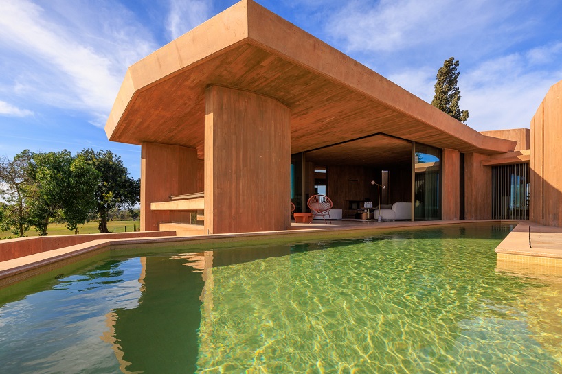 RCR arquitectes’ red concrete resort villa echoes the sandy hues and textures of the algarve
