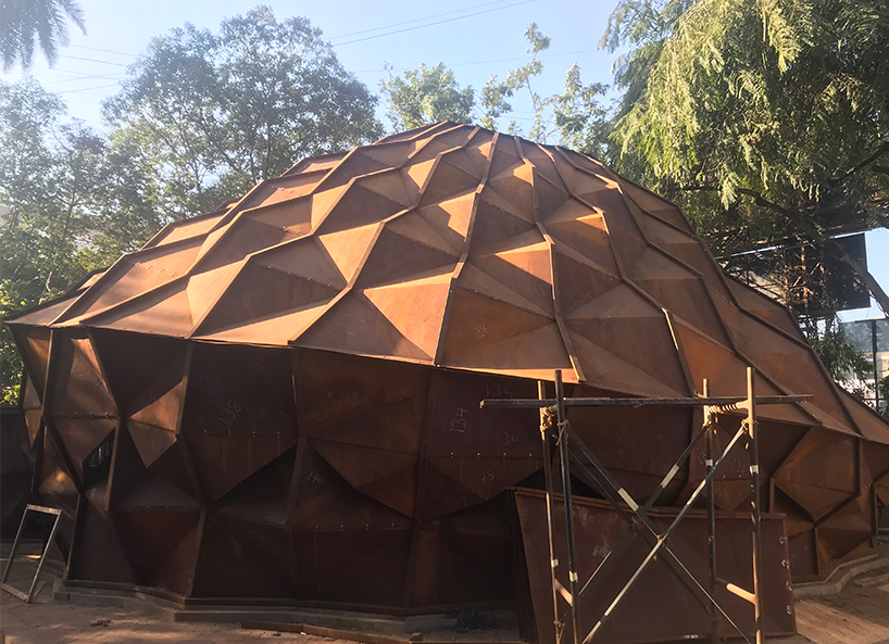 parametric metal tent with ridge paneled facade serves as multipurpose events space in india