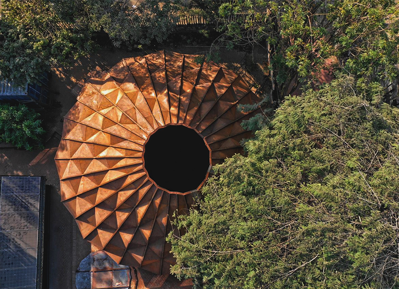 parametric metal tent with ridge paneled facade serves as multipurpose events space by andblack studio in india
