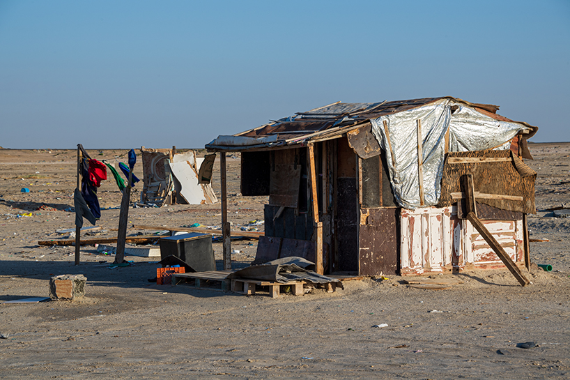 aljohara jeje captures primitive homes made of recycled construction materials + driftwood