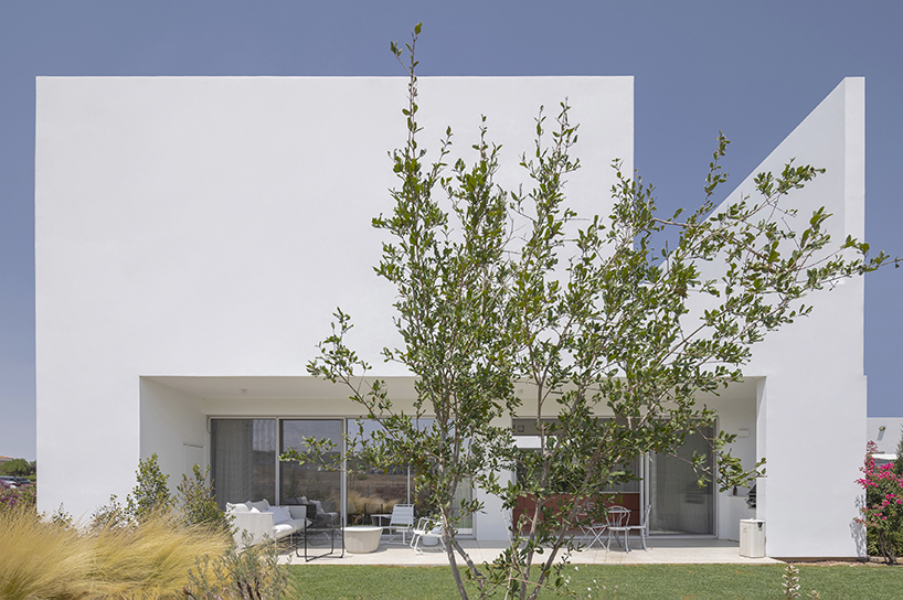 concentric white walls conceal garden-filled residence by draftworks* architects in cyprus