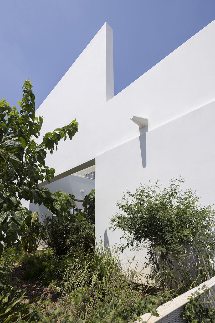 concentric white walls conceal garden-filled residence by draftworks* architects in cyprus