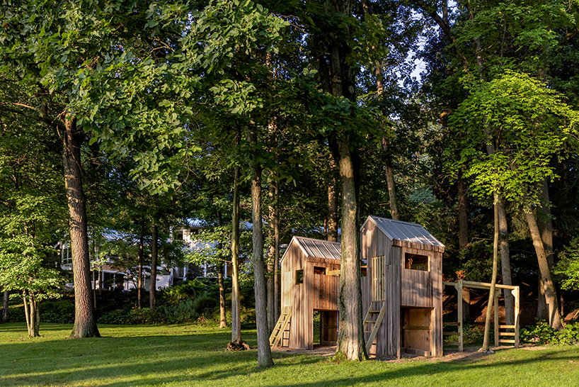 temescal sustainable agency upcycles twin treehouses off a lakeside forest 2