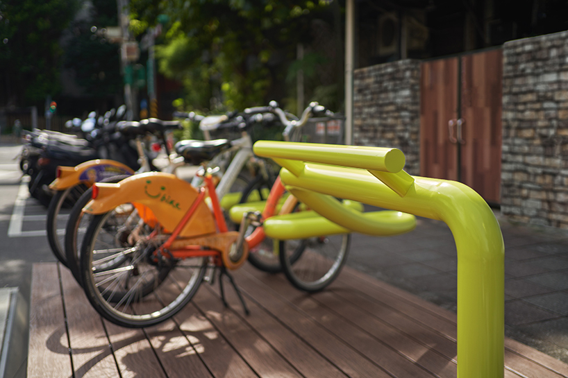 winding tube rack reclaims bustling urban spaces for bike parking and public seating in taipei