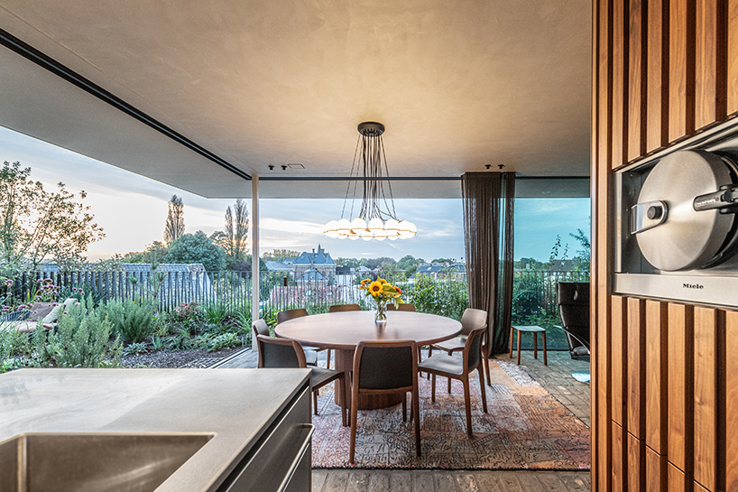rounded volume made of walnut wood lies in the heart of penthouse T by objekt architecten - 3