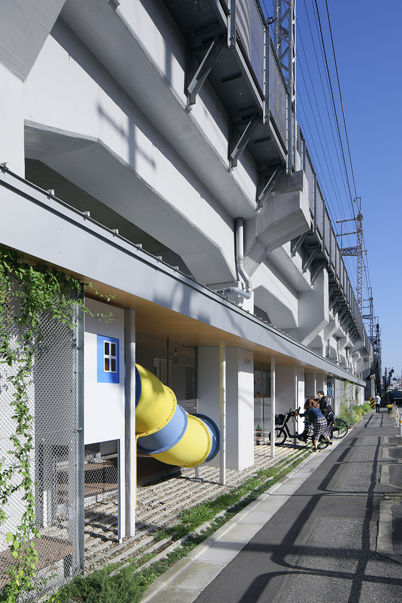 takahiro akiyama architects revives vacant lot under tokyo railway line as school