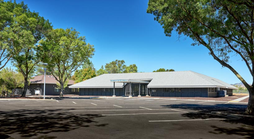university research facility expands under floating asymmetrical pitched roof in california