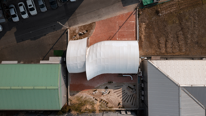 sukchulmok studio imposes PTFE tents onto concrete for photography studio in south korea