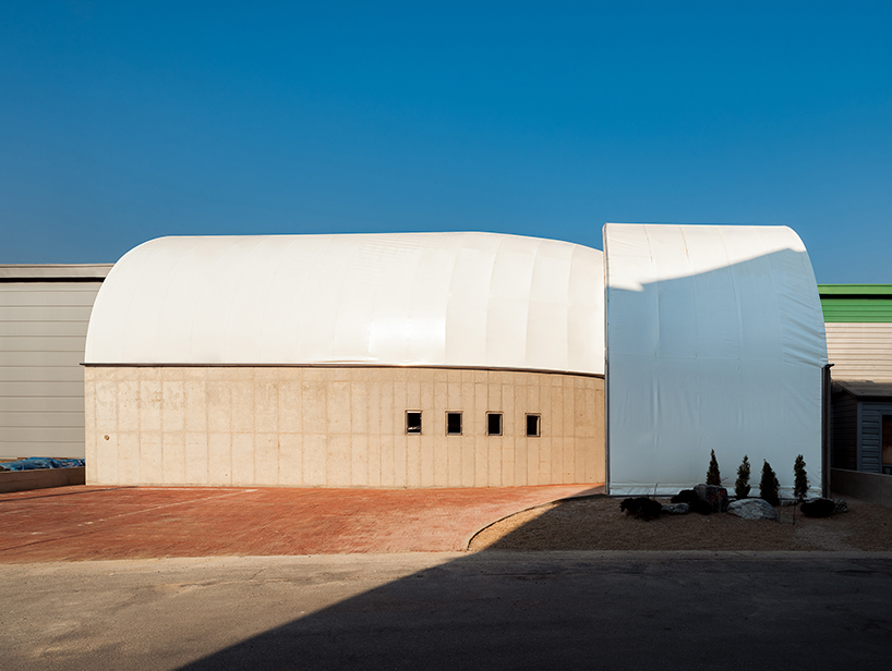 sukchulmok studio imposes PTFE tents onto concrete for photography studio in south korea