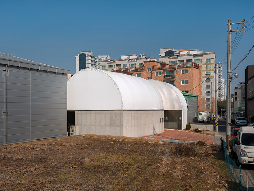 sukchulmok studio imposes PTFE tents onto concrete for photography studio in south korea