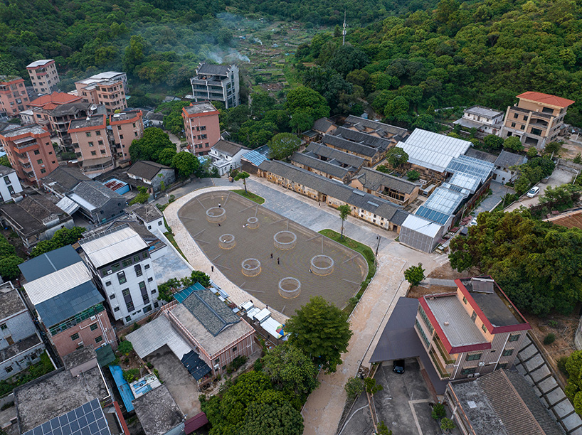 zxd architects stretches large woven net across pond in rural china, inviting rest and play