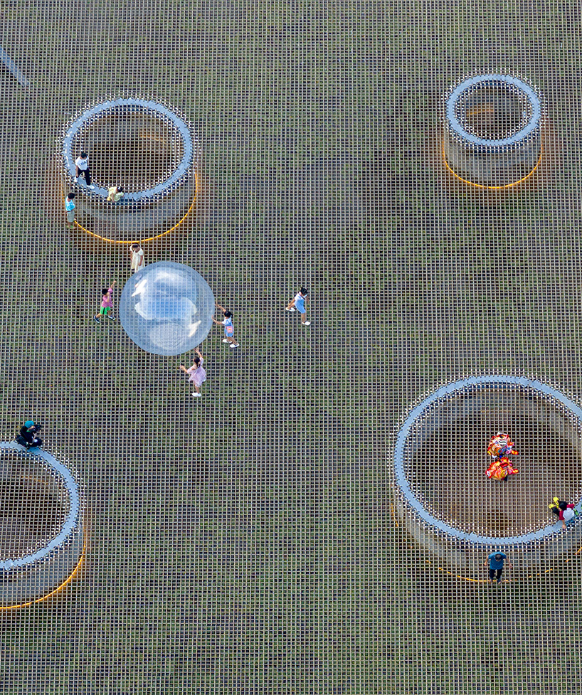 zxd architects stretches large woven net across pond in rural china, inviting rest and play