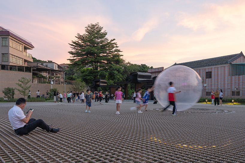 zxd architects stretches large woven net across pond in rural china, inviting rest and play