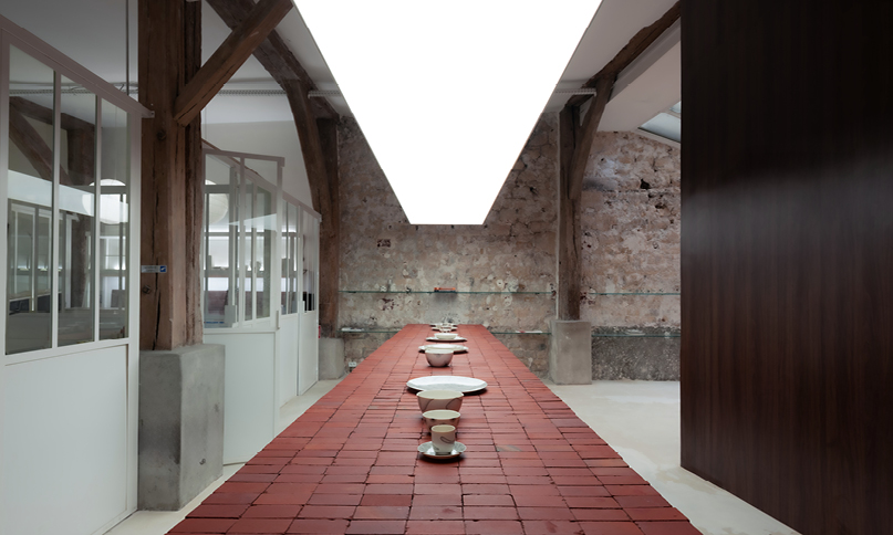 red bricks line the refreshment club's kiln-inspired flagship for parisian porcelain house

