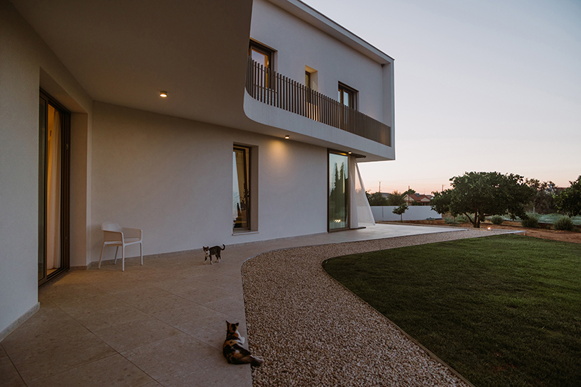 cypress-lined landscape embraces versa architecture's villa JJ in cyprus