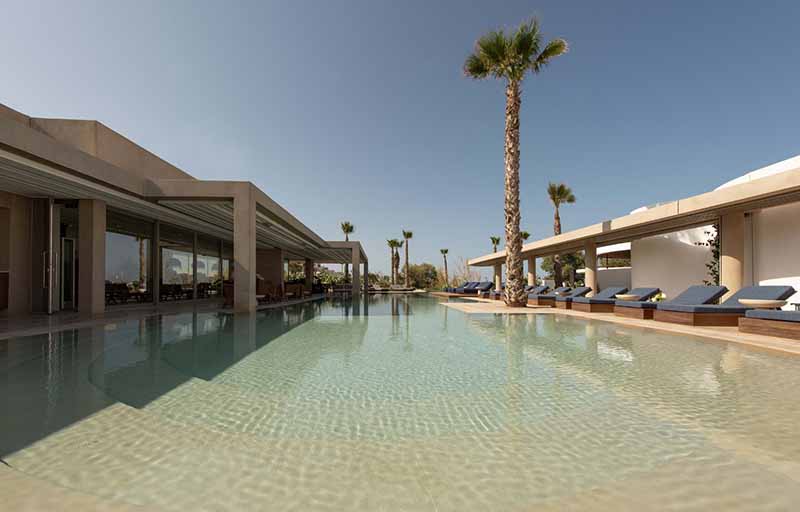 cubic and circular volumes by tense architecture network develop around resort's swimming pool in greece