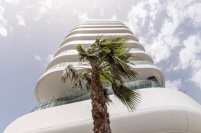 two rippling volumes unite luxury commercial and residential spaces at limassol del mar, cyprus