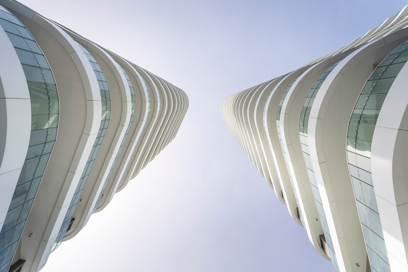 two rippling volumes unite luxury commercial and residential spaces at limassol del mar, cyprus