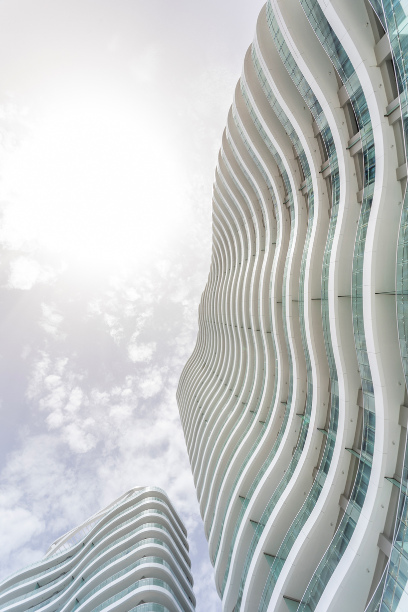 two rippling volumes unite luxury commercial and residential spaces at limassol del mar, cyprus